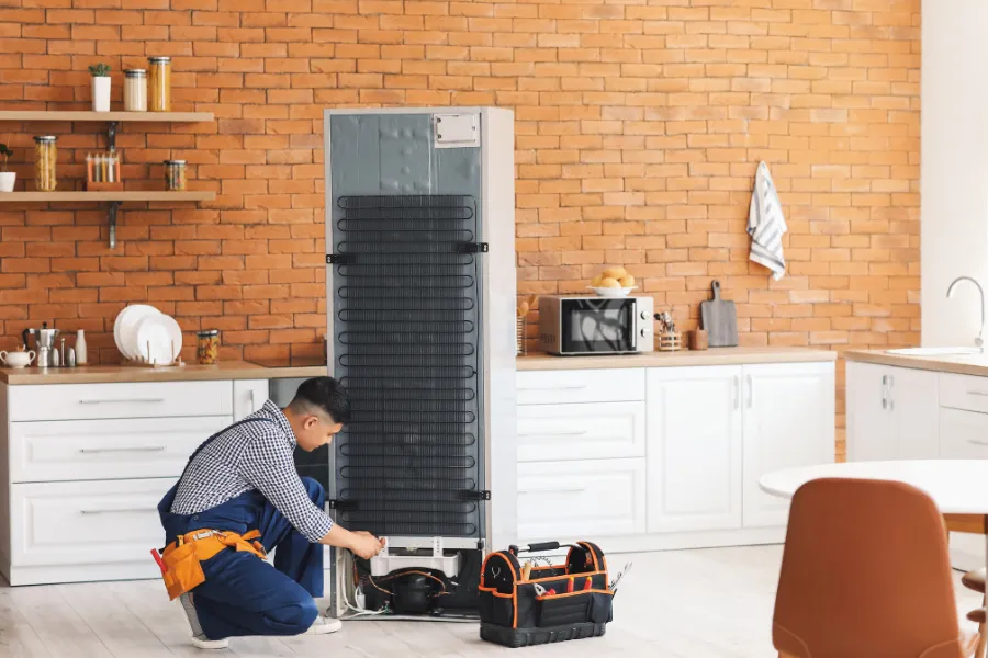technician inspecting refrigerator cooling issue