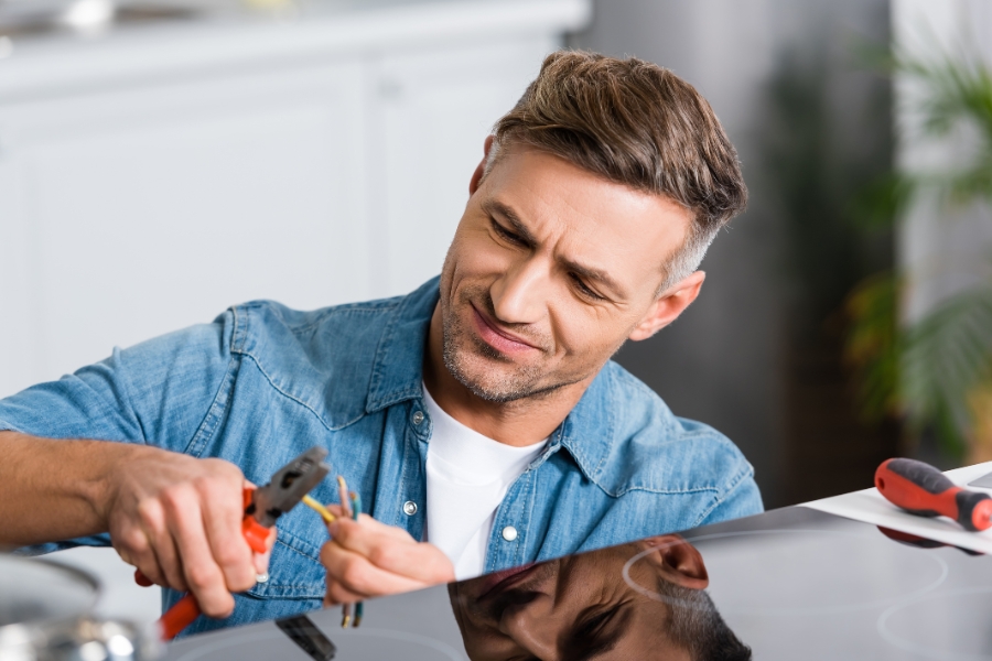 man repairing stove