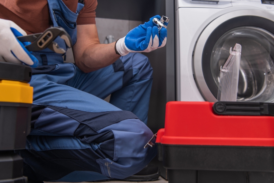 man repairing a washer making loud noises