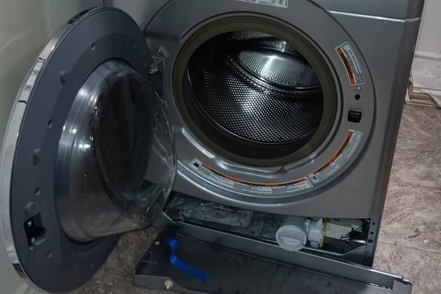 technicians replacing a washer's drain pump