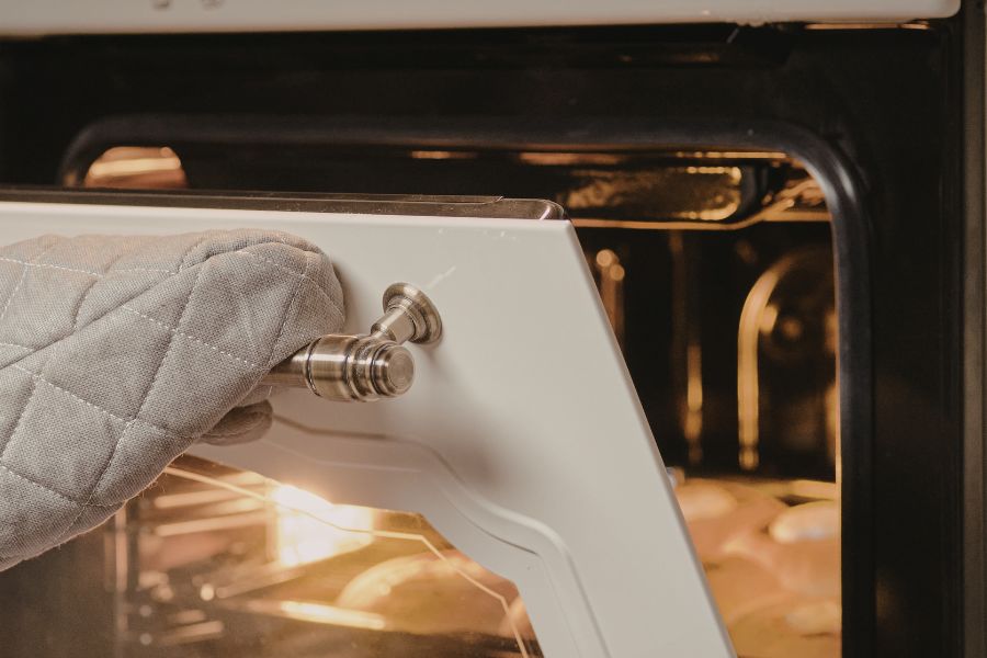 appliance technician fixing oven light